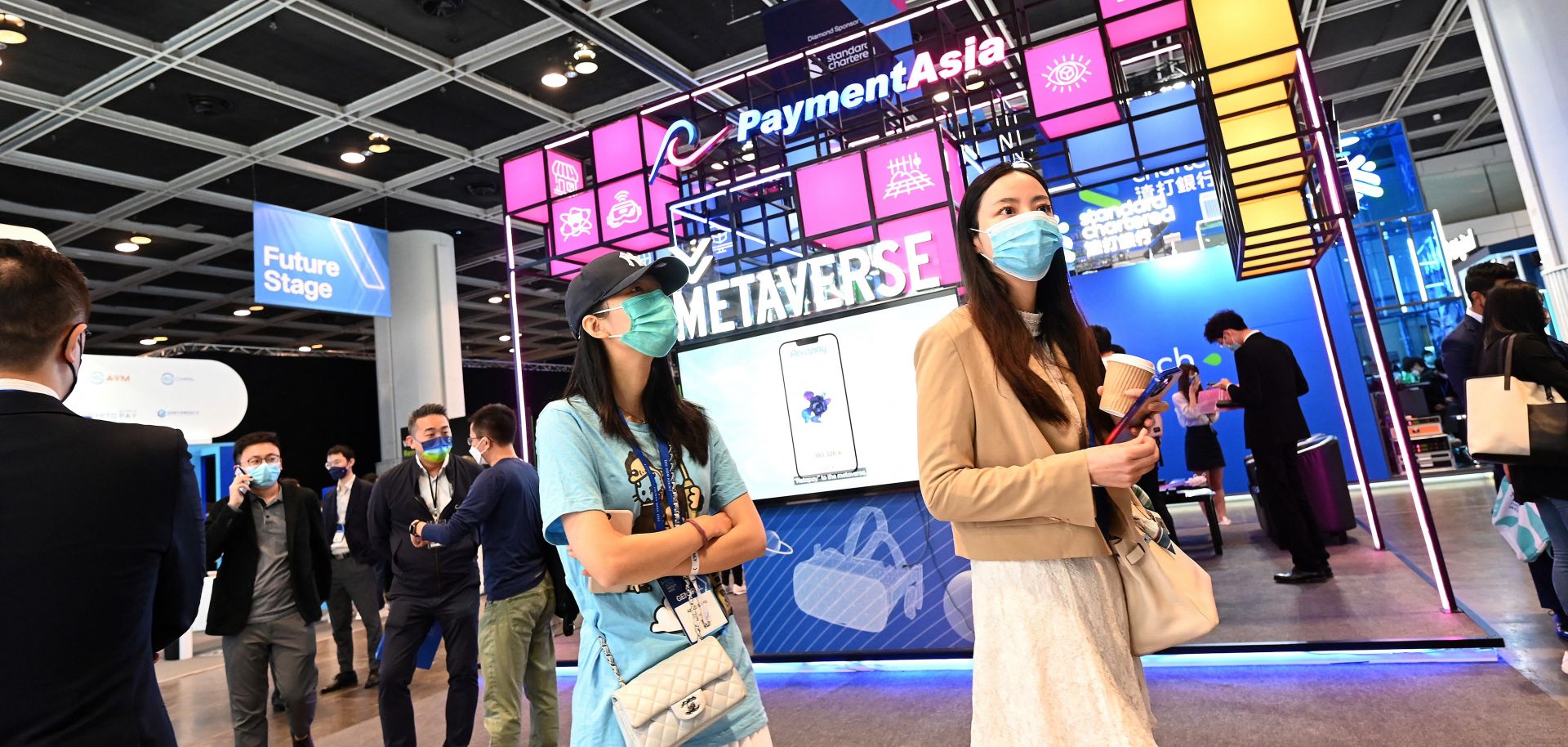 Visitors walk past a metaverse stand during Fintech Week 2022 in Hong Kong on Nov. 1, 2022. 