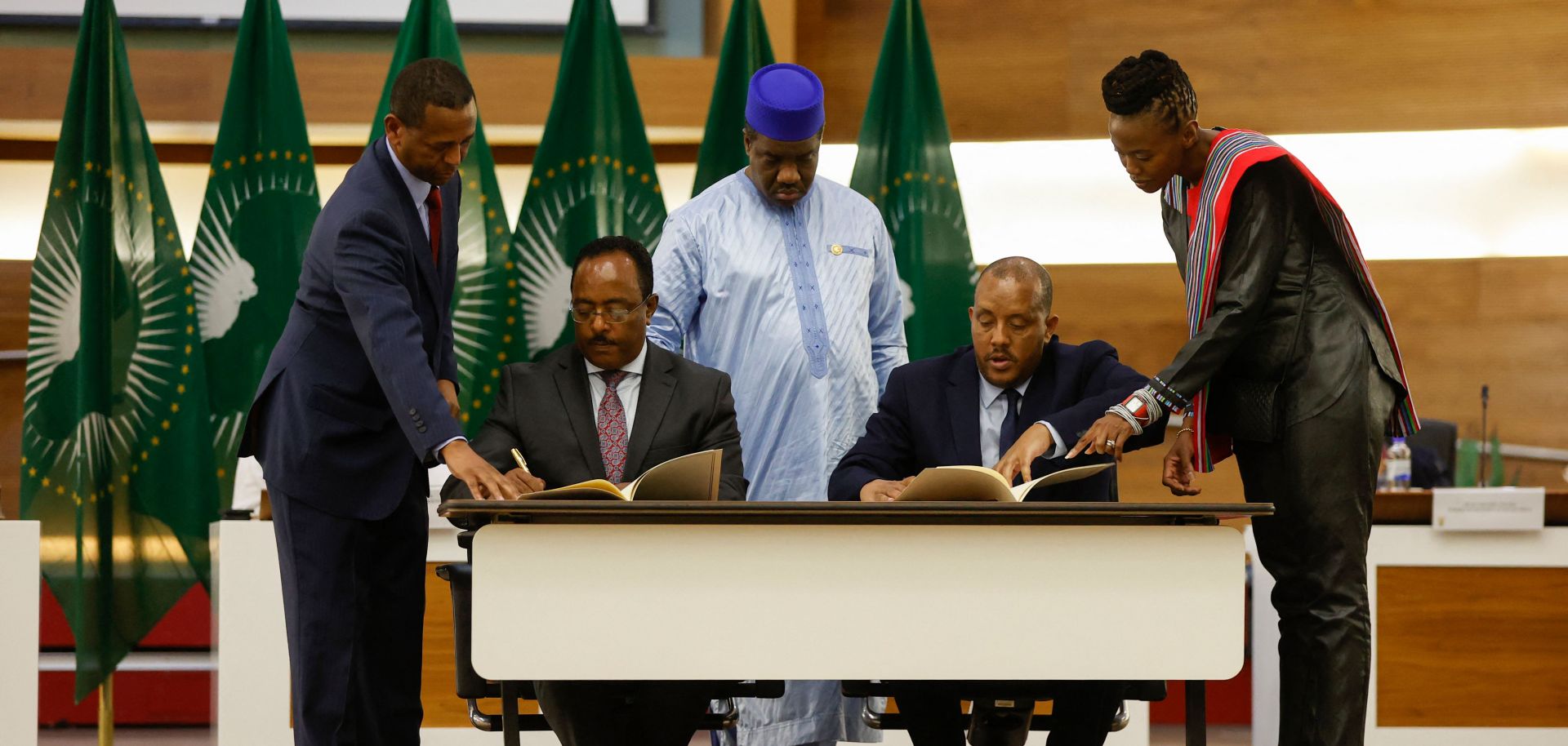 Redwan Hussein (second from the left), a representative of the Ethiopian government, and Getachew Reda (second from the right), a representative of the Tigray People's Liberation Front (TPLF), sign a peace agreement in Pretoria, South Africa, on Nov. 2, 2022.