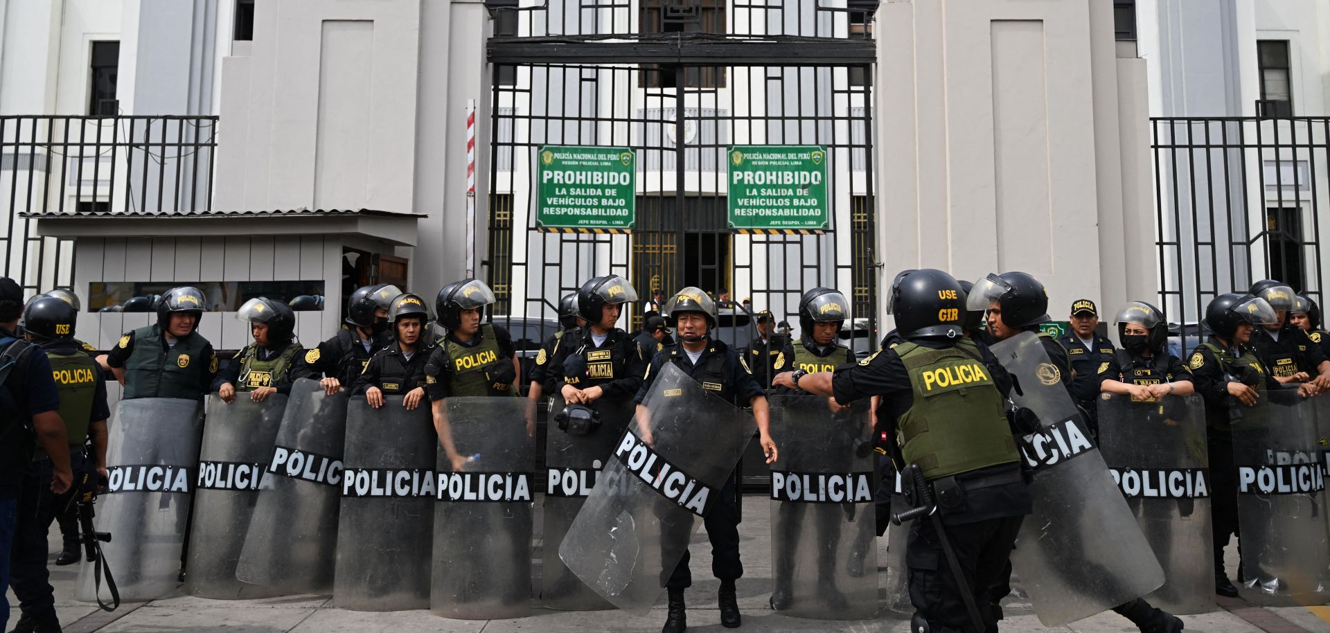 Police officers stand guard outside the Lima Prefecture, where Peruvian President Pedro Castillo was detained after he tried to dissolve Congress, in Lima on Dec. 7, 2022. 