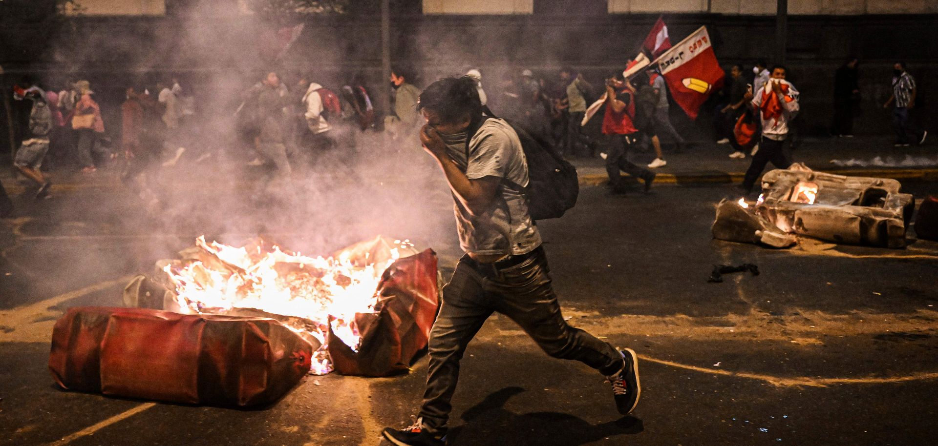 Supporters of former Peruvian President Pedro Castillo clash with riot police in Lima on Dec. 11, 2022, during a demonstration demanding Castillo's release and early legislative elections. 