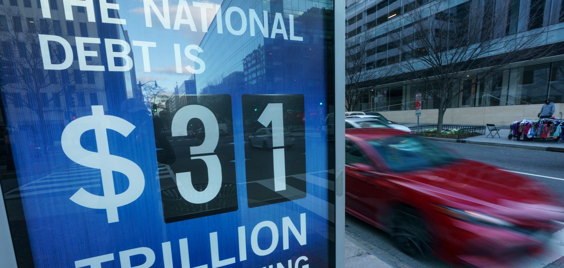 A sign at a bus shelter shows the national debt in Washington, D.C., on Jan. 20, 2023.