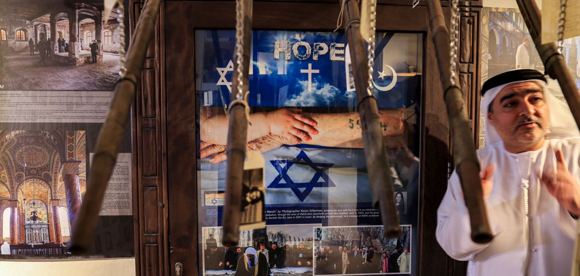 The director of the Museum at the Crossroads of Civilizations in Dubai, United Arab Emirates, shows visitors the facility's Holocaust gallery, January 11, 2023.