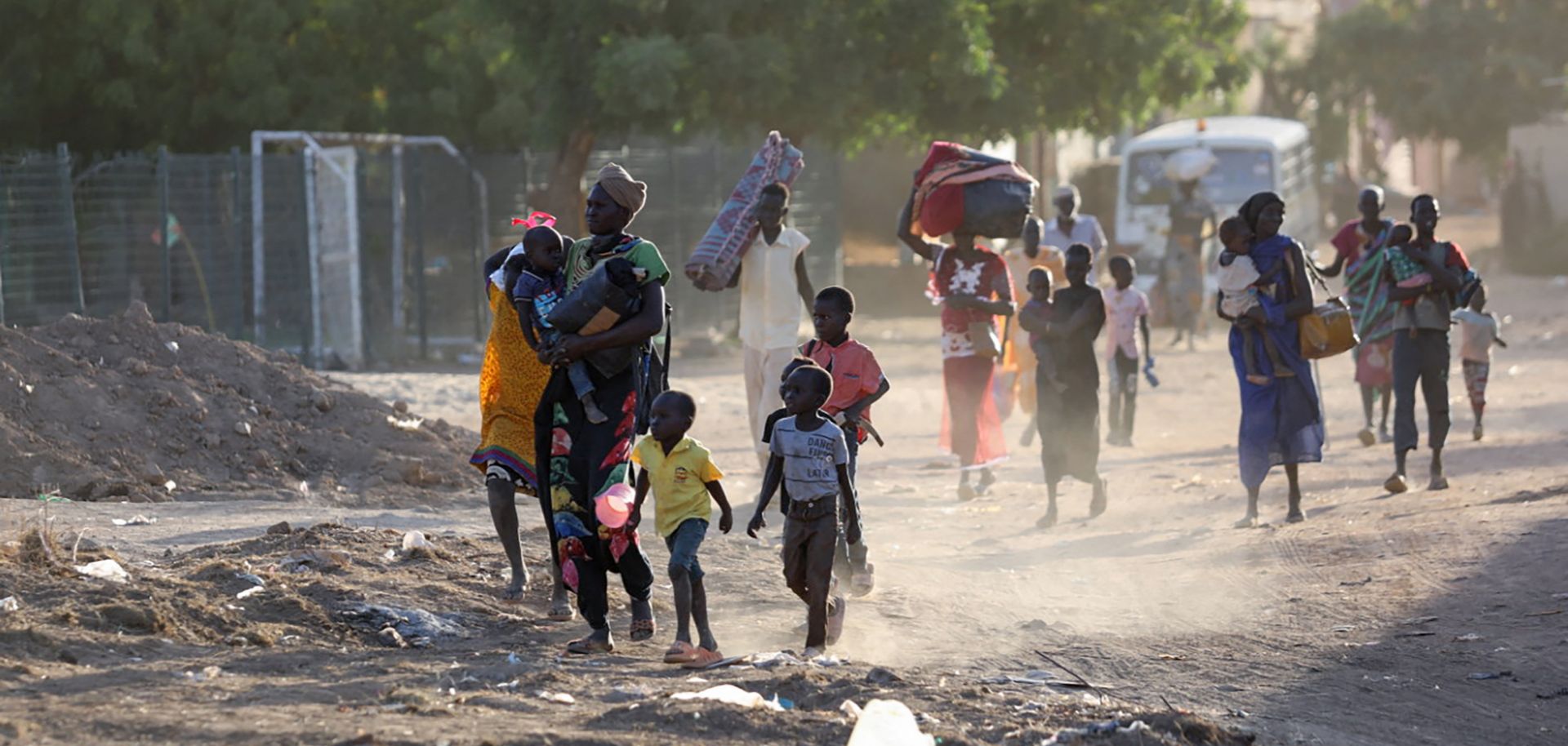 People flee their neighborhoods in Khartoum, Sudan, amid fighting between the army and paramilitary troops on April 19, 2023. 