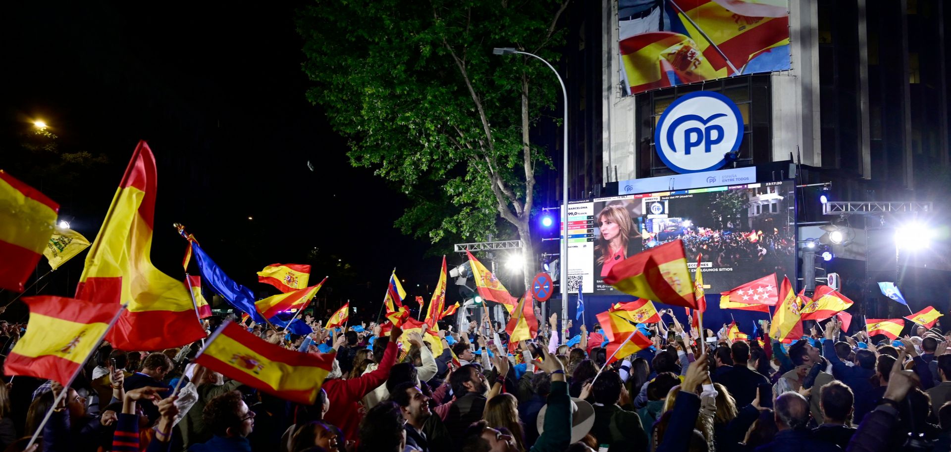 Supporters of Spain's center-right Popular Party (PP) gather outside the PP's headquarters in Madrid on May 28, 2023, to celebrate the party's strong performance in recent regional elections.