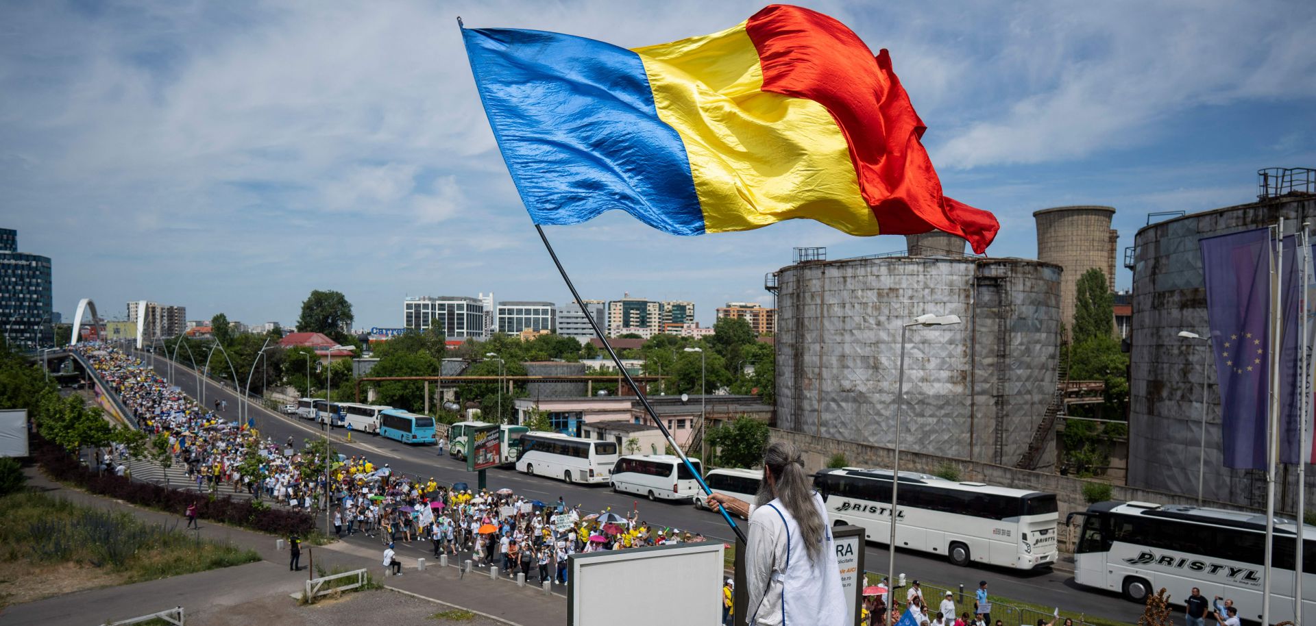 The Romanian flag is waved above a teachers' protest in Bucharest, Romania, on June 9, 2023. 