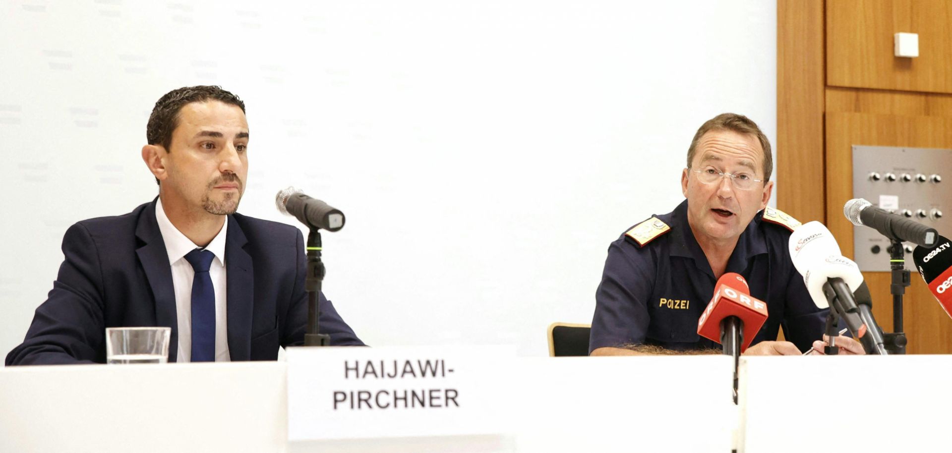 The director of Austria's intelligence agency (left) and the president of Vienna's state police hold a press conference on a foiled Vienna pride parade attack on June 18, 2023. 