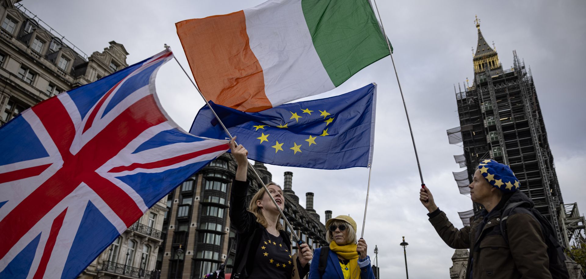 Anti-Brexit protesters wave the flags of the United Kingdom, Ireland and the European Union outside the U.K. Parliament building in London on Oct. 13, 2021. 