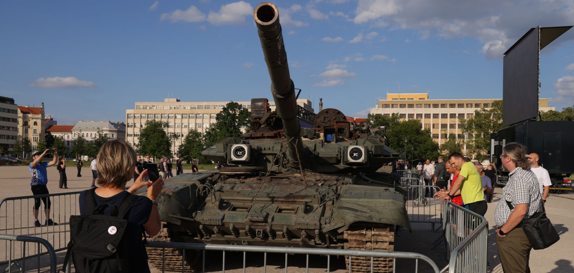 People look at a Russian T-90 tank in Prague, Czech Republic, on July 15, 2022, as part of a display of military equipment destroyed in the war in Ukraine. 