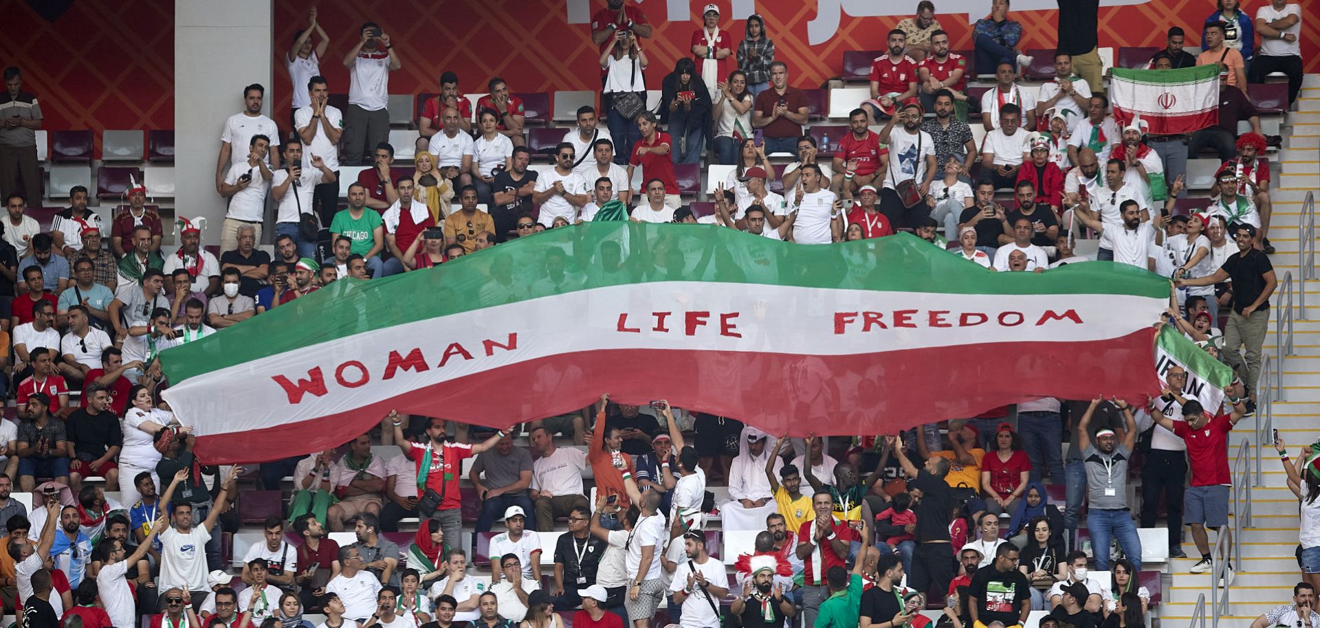 Iranian soccer fans hold up a ''Woman Life Freedom'' sign in solidarity with the protests at home during Iran's match with England at the World Cup in Doha, Qatar, on Nov. 21, 2022. 