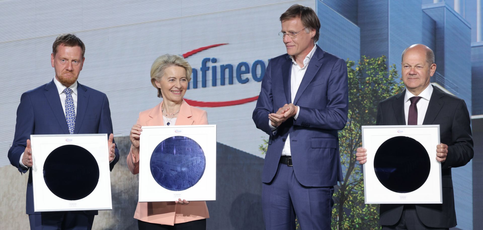 (L-R) Saxony Premier Michael Kretschmer, European Commission President Ursula von der Leyen and German Chancellor Olaf Scholz hold semiconductor wafers as Infineon CEO Jochen Hanebeck (second from right) looks on during a ground-breaking ceremony for a new semiconductor factory in Dresden, Germany, on May 2, 2023. 