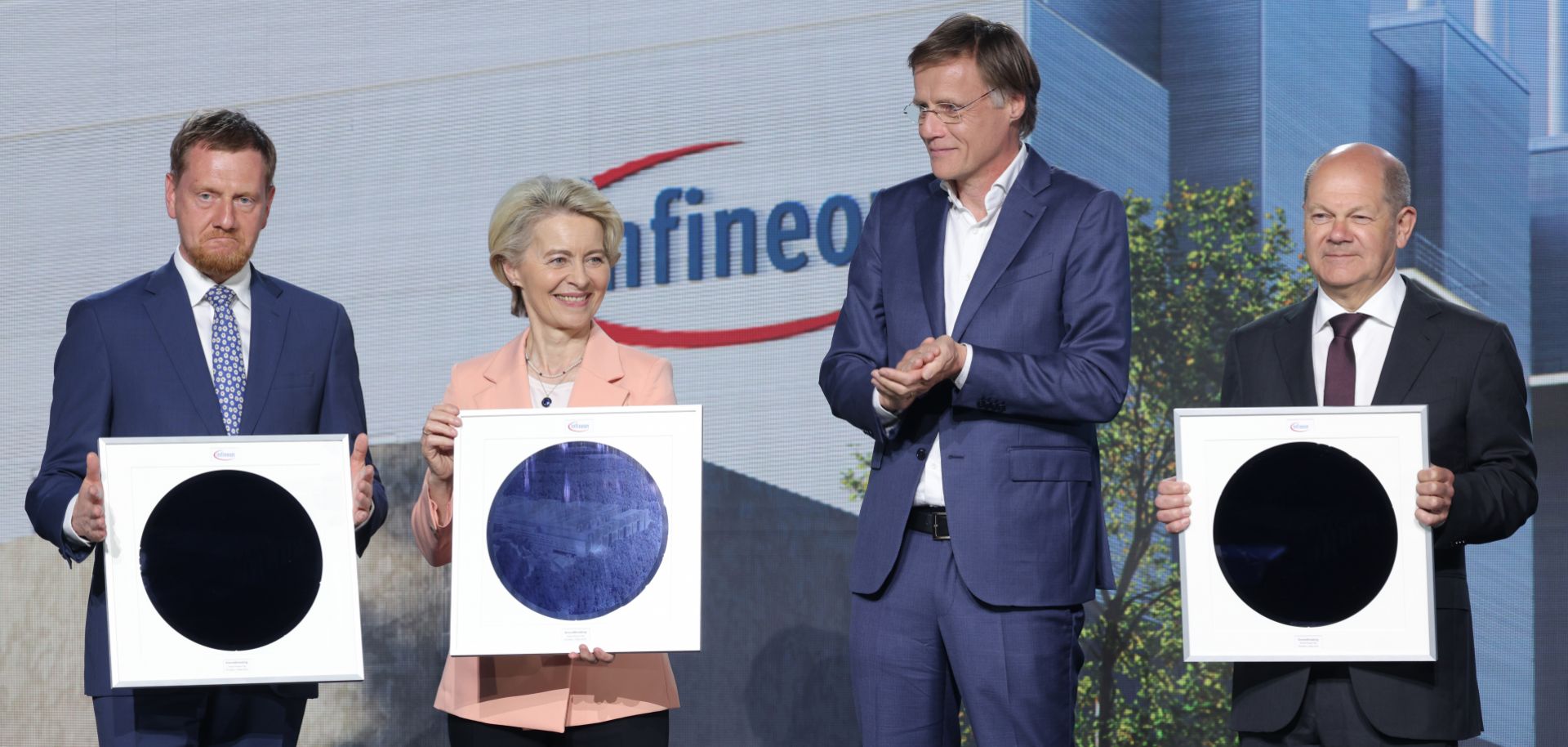 (L-R) Saxony Premier Michael Kretschmer, European Commission President Ursula von der Leyen and German Chancellor Olaf Scholz hold semiconductor wafers as Infineon CEO Jochen Hanebeck (second from right) looks on during a ground-breaking ceremony for a new semiconductor factory in Dresden, Germany, on May 2, 2023.
