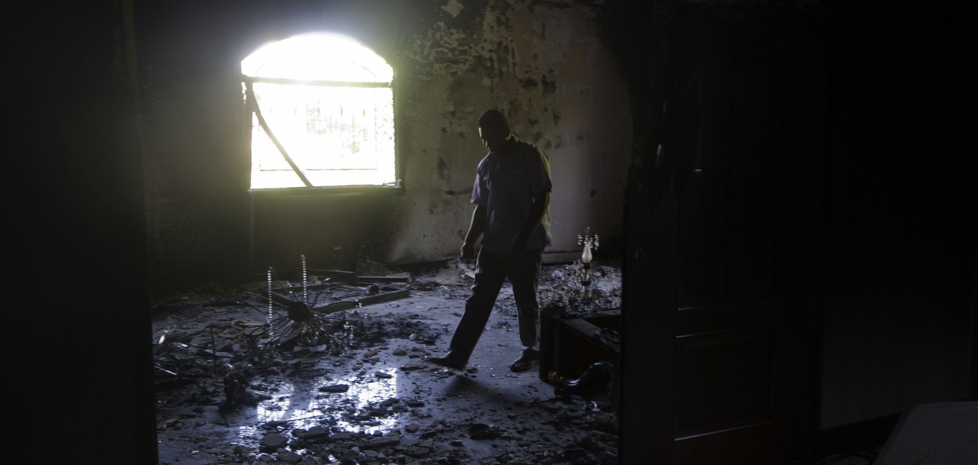 A Libyan man walks through the debris of the damaged US ambassador's residence in the US consulate compound in Benghazi on September 13, 2012, following an attack on the building late on September 11 in which the US ambassador to Libya and three other US nationals were killed.