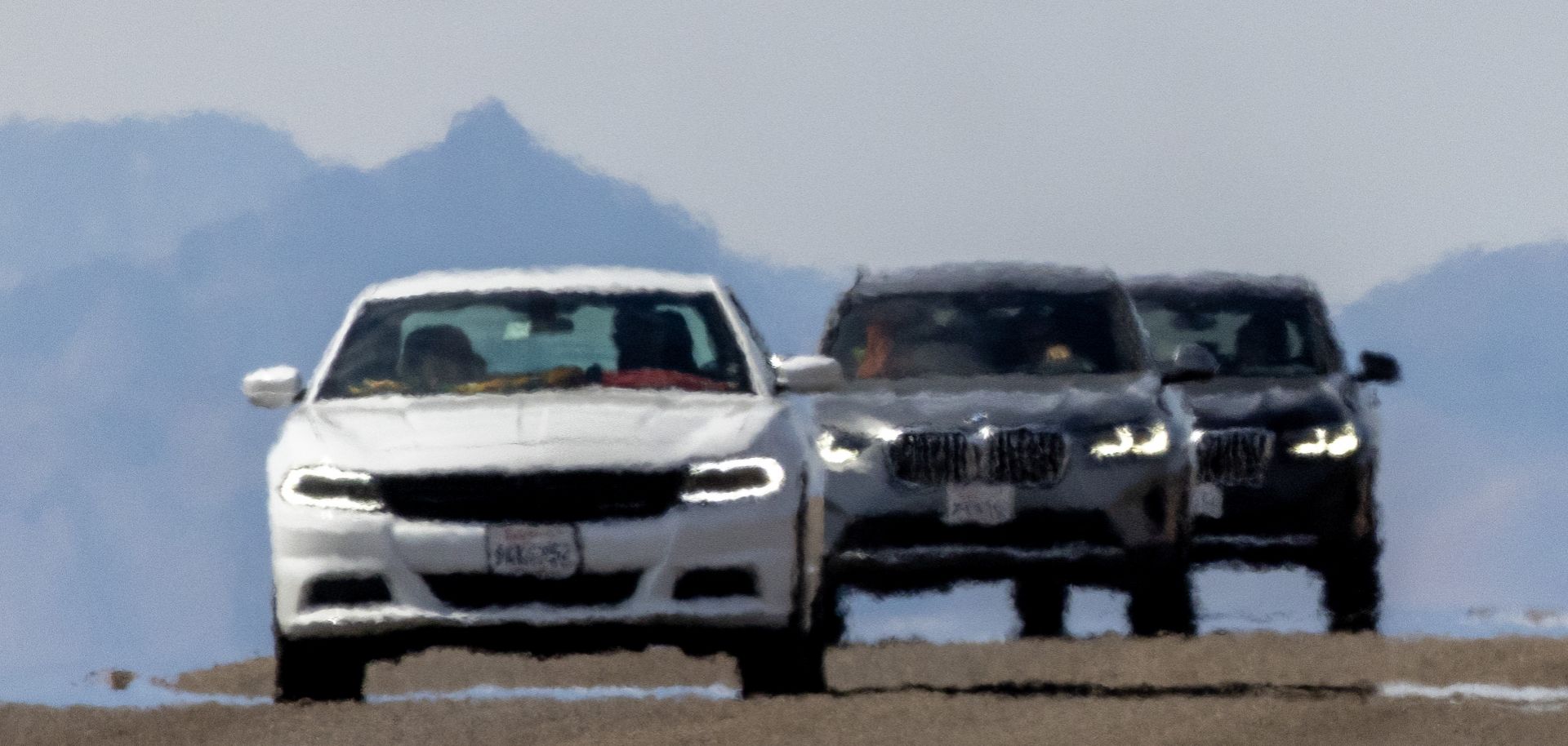 Cars shimmer in the heat haze near Death Valley National Park in California on July 16, 2023, a day that saw temperatures rise past about 127 degrees Fahrenheit. The highest temperature reliably recorded on Earth was 129.2 F in Death Valley in 2013. 