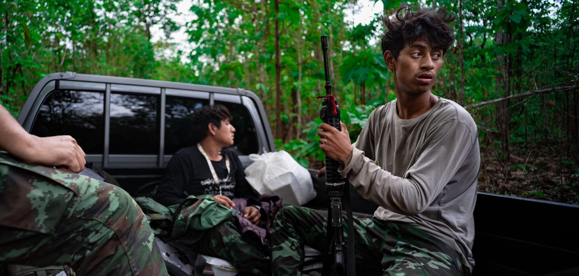 A member of the Karenni Revolutionary Union (KRU) is seen in the back of a pick-up truck on May 10, 2023, in Kayah State, Myanmar.