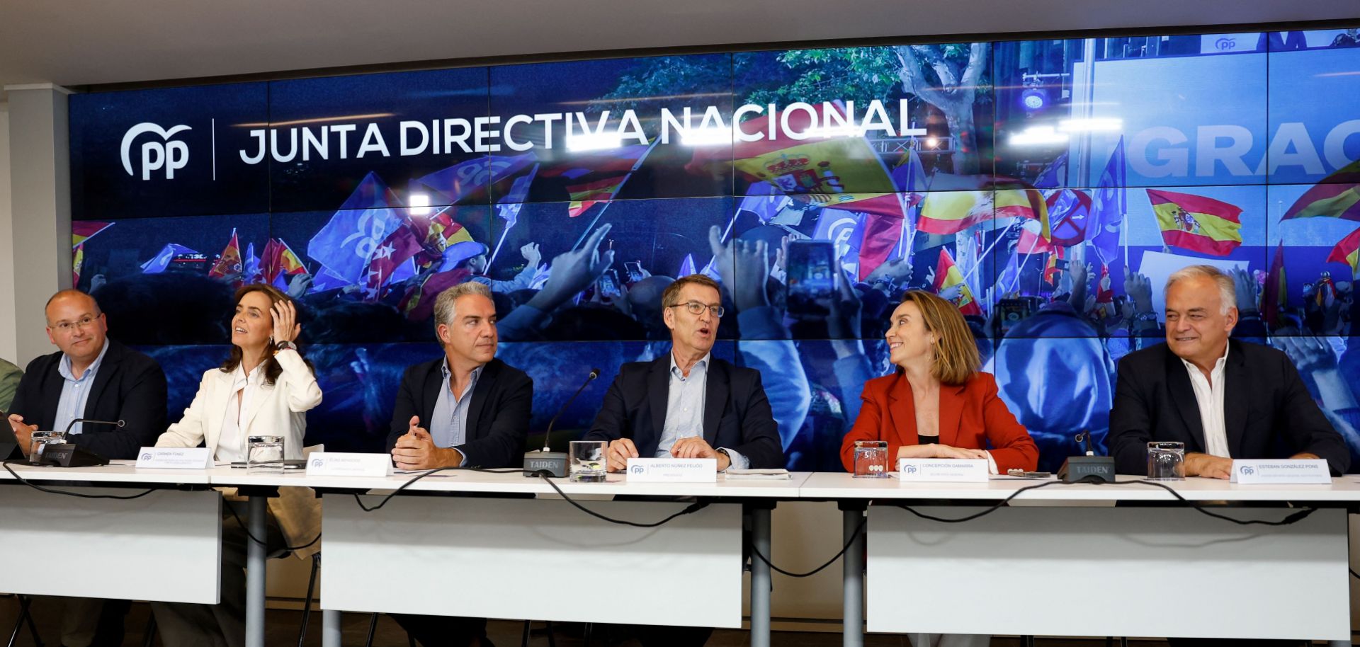 The leader of Spain's center-right People's Party, Alberto Nunez Feijoo (center), and other top party officials answer questions during a post-election press conference in Madrid on July 24, 2023.