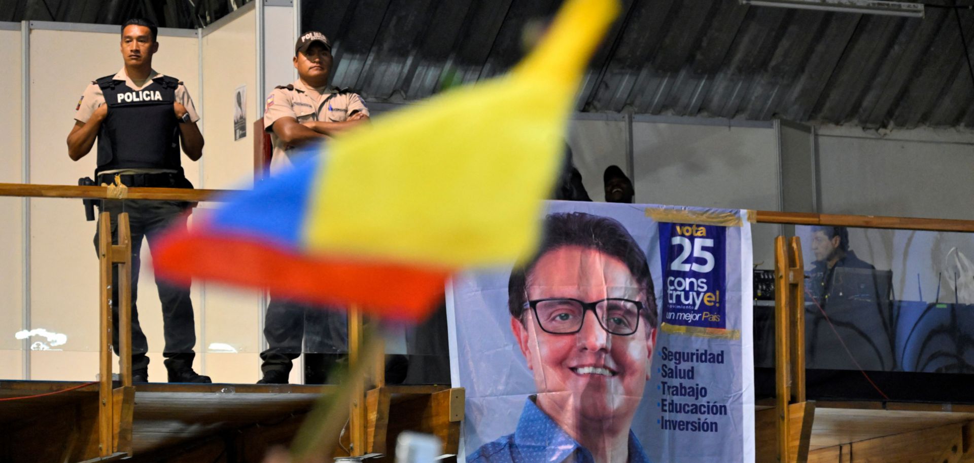 Policemen stand guard while supporters of slain Ecuadorian presidential candidate Fernando Villavicencio pay their respects at the Quito Exhibition Center in Quito, Ecuador, on Aug. 11, 2023. 