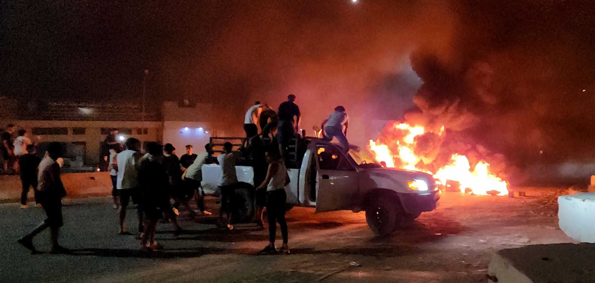 Libyan protesters burn tires in Tripoli on Aug. 28, 2023, in response to reports that their country's foreign minister met with her Israeli counterpart. 