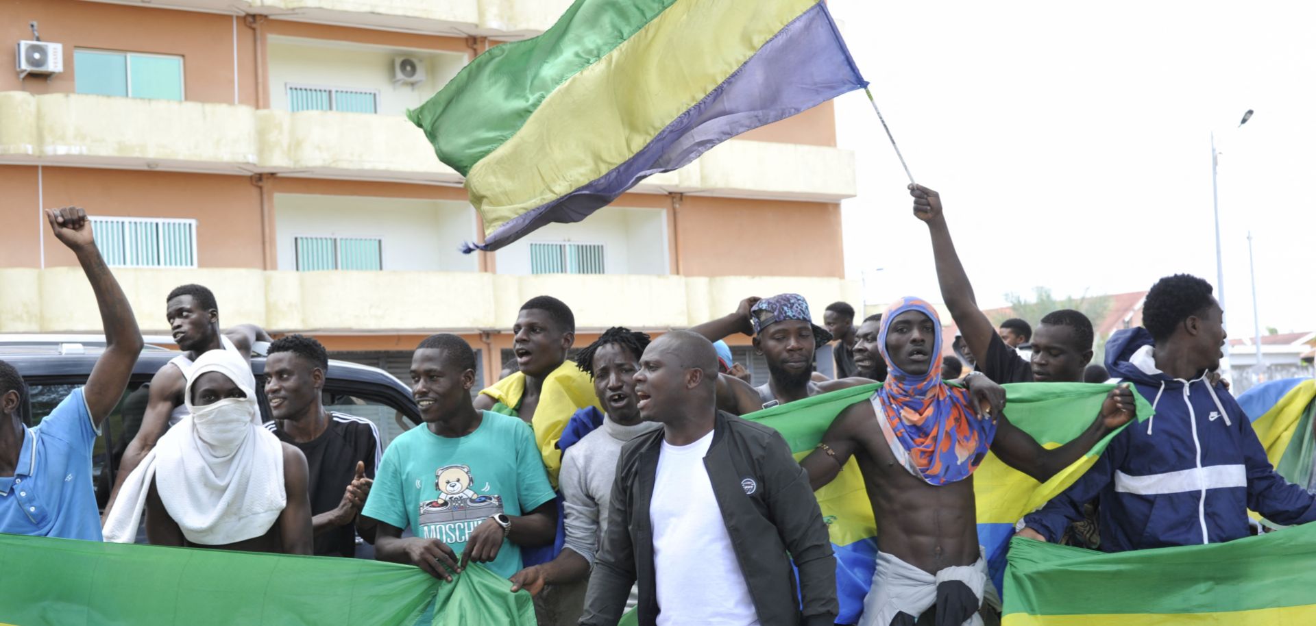People holding Gabon national flags celebrate in Libreville on August 30, 2023, after a group of military officers announced they were ''putting an end'' to President Ali Bongo Ondimba's regime. 