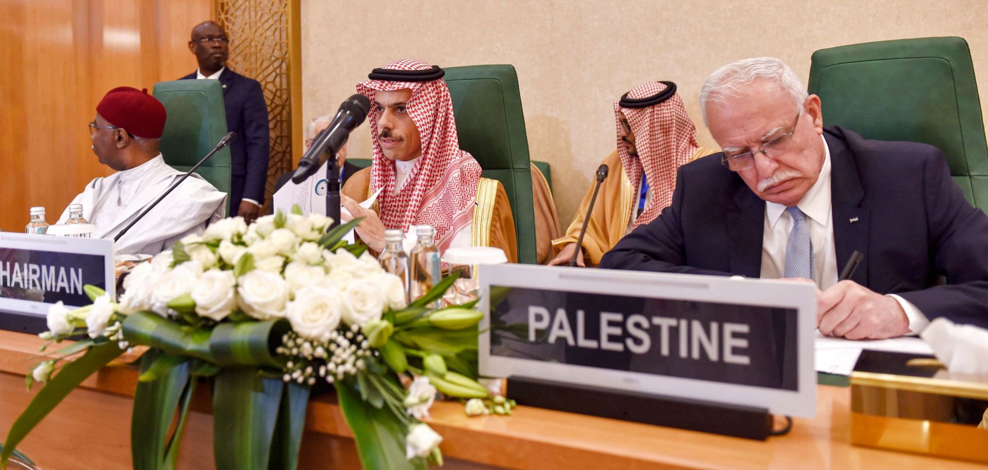 Saudi Foreign Minister Prince Faisal bin Farhan (center) sits next to his Palestinian counterpart during an extraordinary meeting of the Organization of Islamic Cooperation's executive committee regarding the situation in Gaza on Oct. 18, 2023 in Jeddah, Saudi Arabia.