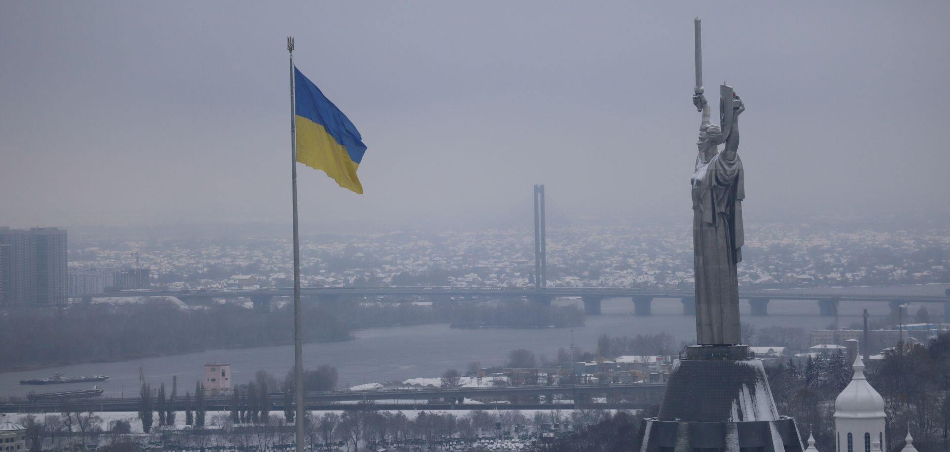 A Ukrainian flag flies near the Great Lavra Bell Tower of the Motherland Monument in Kyiv, Ukraine, on Nov. 22, 2023.