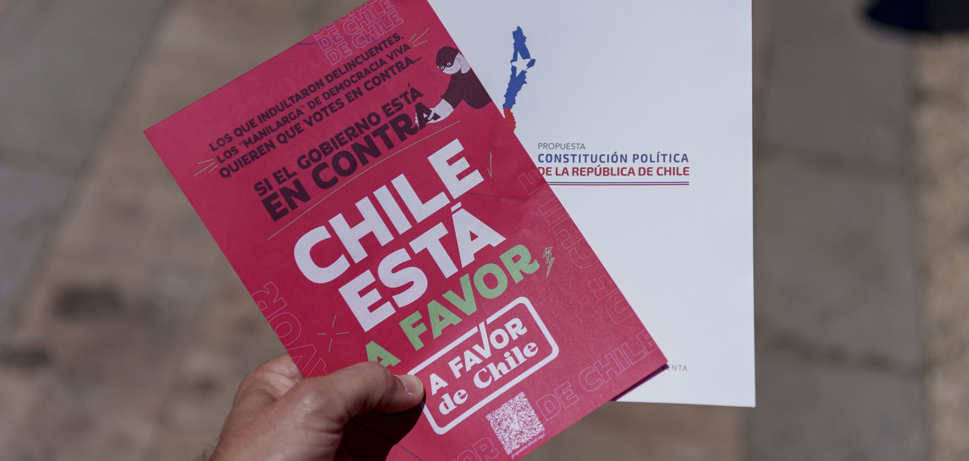 A man holds a handout in support of Chile’s proposed new constitution on Dec. 6, 2023, in Santiago.