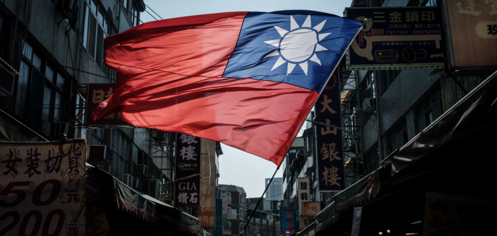 A supporter of the main opposition Kuomintang (KMT) waves Taiwan's national flag during a campaign rally at the Sanhe Market in Kaohsiung, Taiwan, on Jan. 10, 2024.