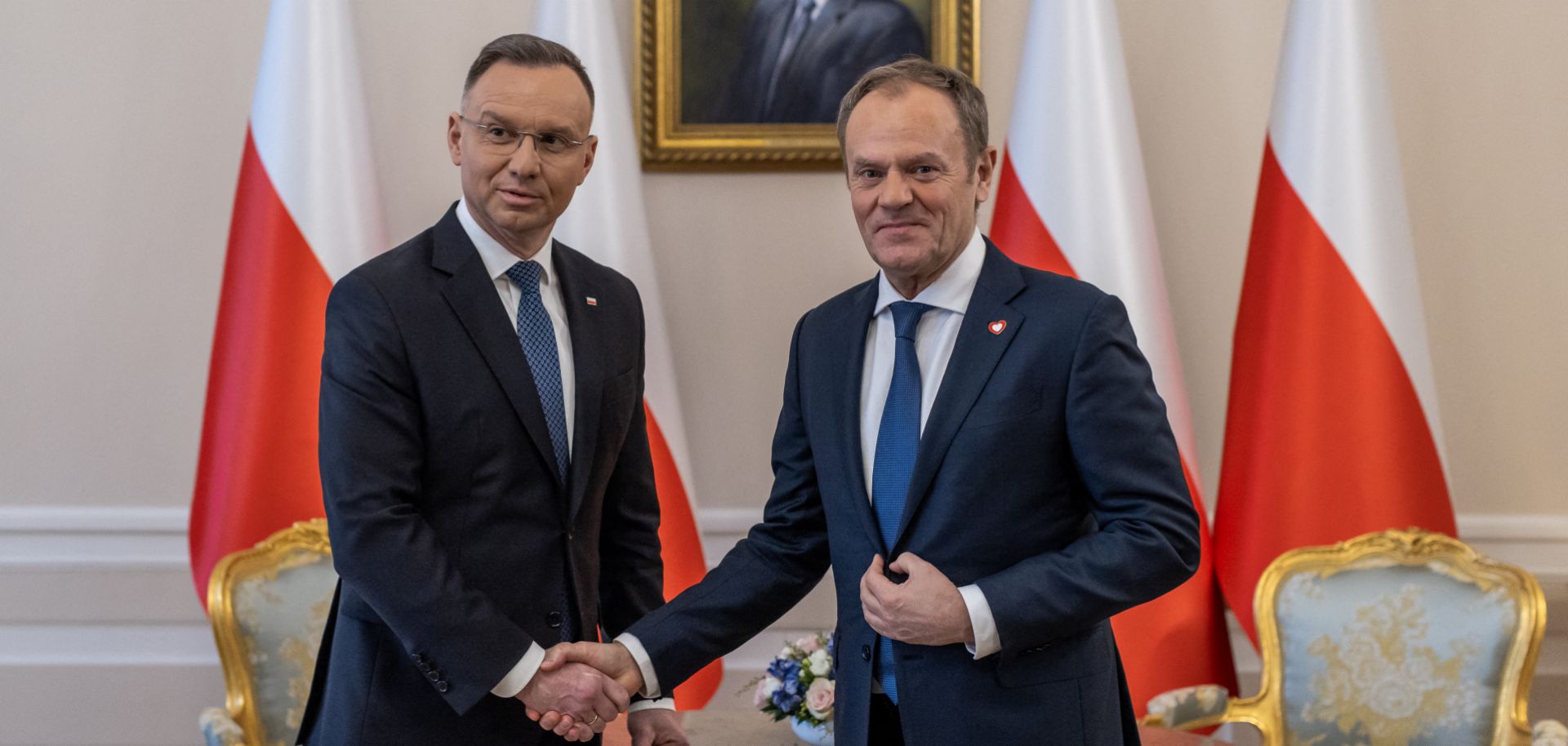 Polish President Andrzej Duda (left) and Polish Prime Minister Donald Tusk (right) shake hands during their meeting at the Presidential Palace in Warsaw, Poland, on Jan. 15, 2024. 