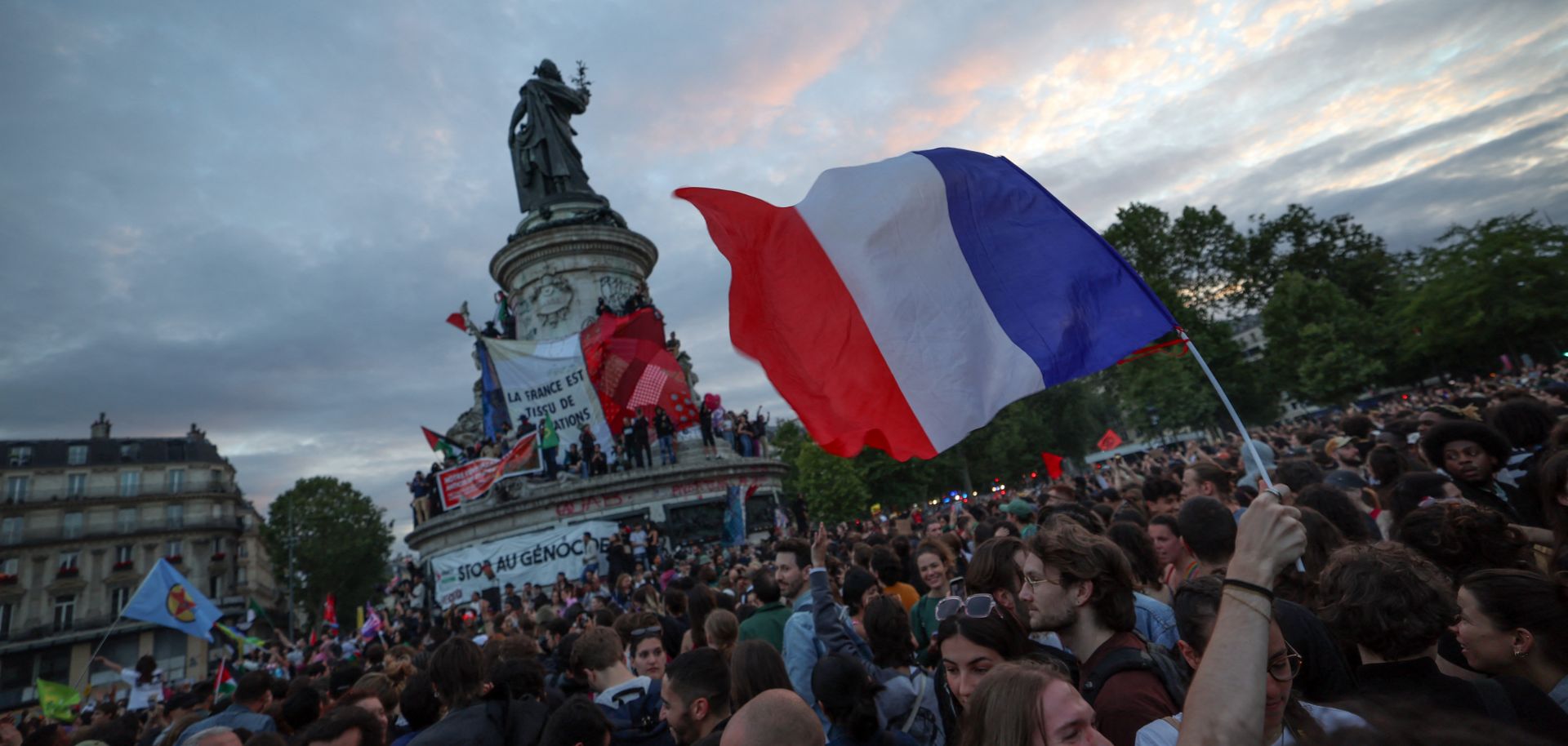 A French flag is waved during a rally following the projected results of the second round of France's legislative election, at Place de la Republique in Paris on July 7, 2024.