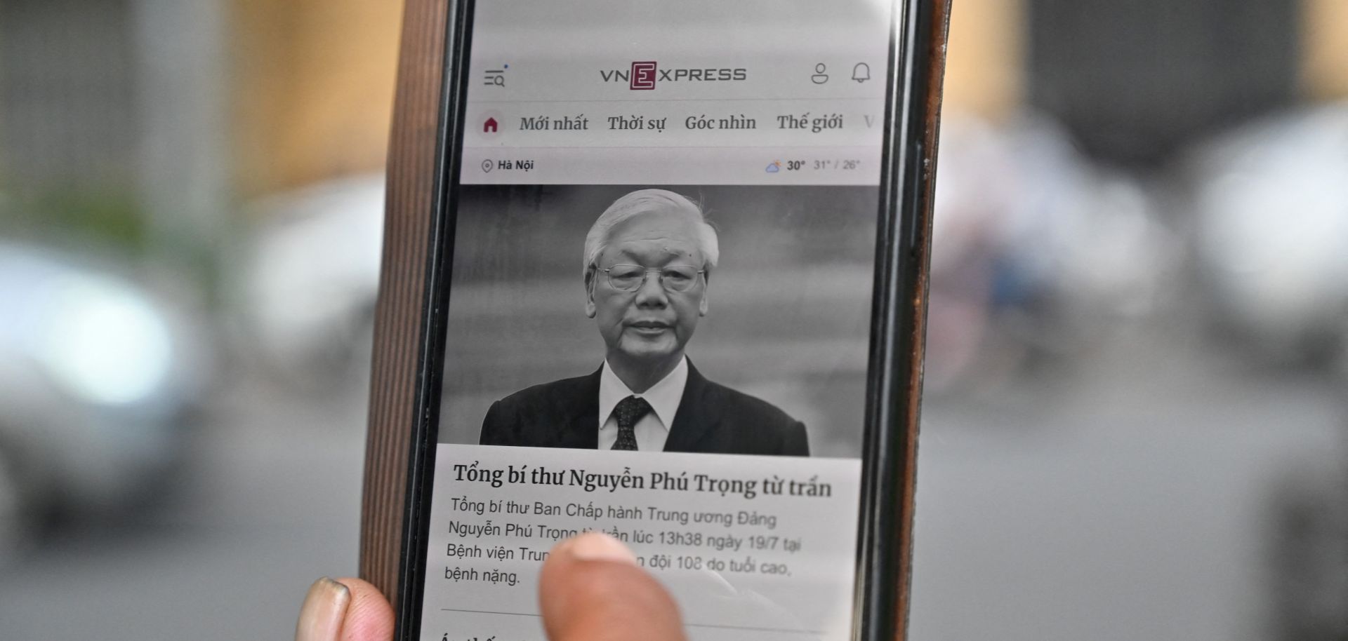 A man in Hanoi, Vietnam, reads a news article on the death of the country’s top leader, Nguyen Phu Trong, on his phone on July 19, 2024.