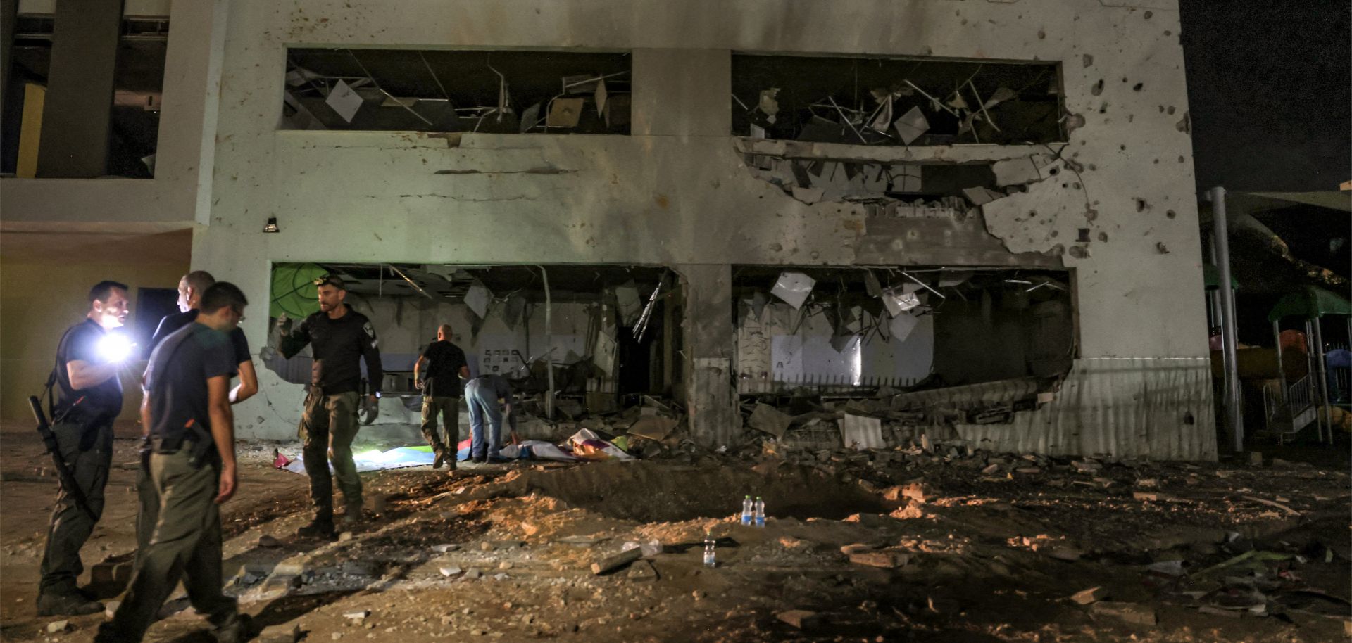 Authorities in Israel's southern city of Gedera assess a damaged school building after a projectile exploded upon impact on Oct. 1, 2024, after Iran launched a barrage of missiles at Israel. 