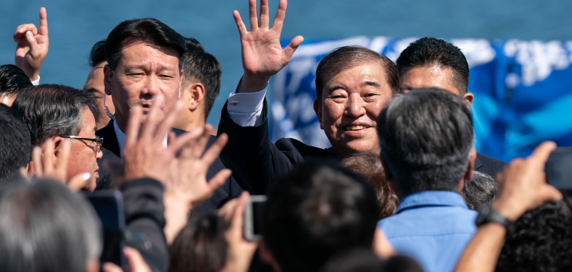 Japanese Prime Minister Shigeru Ishiba (center) waves as he arrives for a campaign rally at Onahama Port in Iwaki, Japan, on Oct. 15, 2024. 