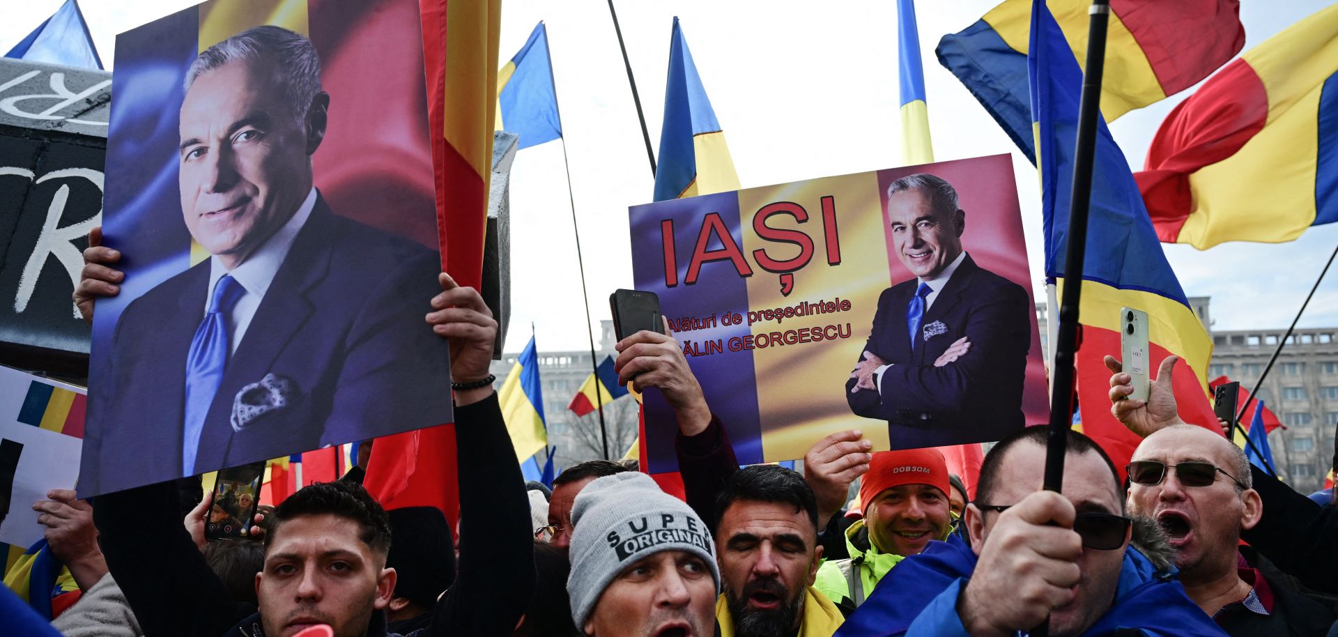 People wave Romanian flags and hold portraits of far-right presidential candidate Calin Georgescu during a protest in front of Romania's Constitutional Court in Bucharest on Jan. 10, 2025. 