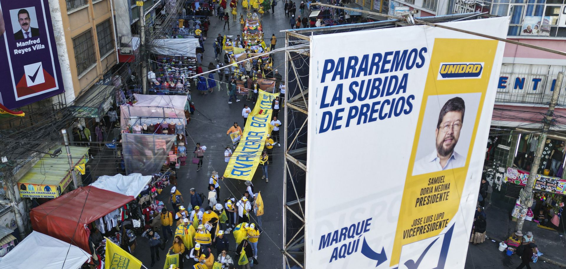 An aerial view shows a campaign poster of Bolivian presidential candidate Samuel Doria Medina and his supporters marching during a rally in La Paz, Bolivia, on Aug. 12, 2025.