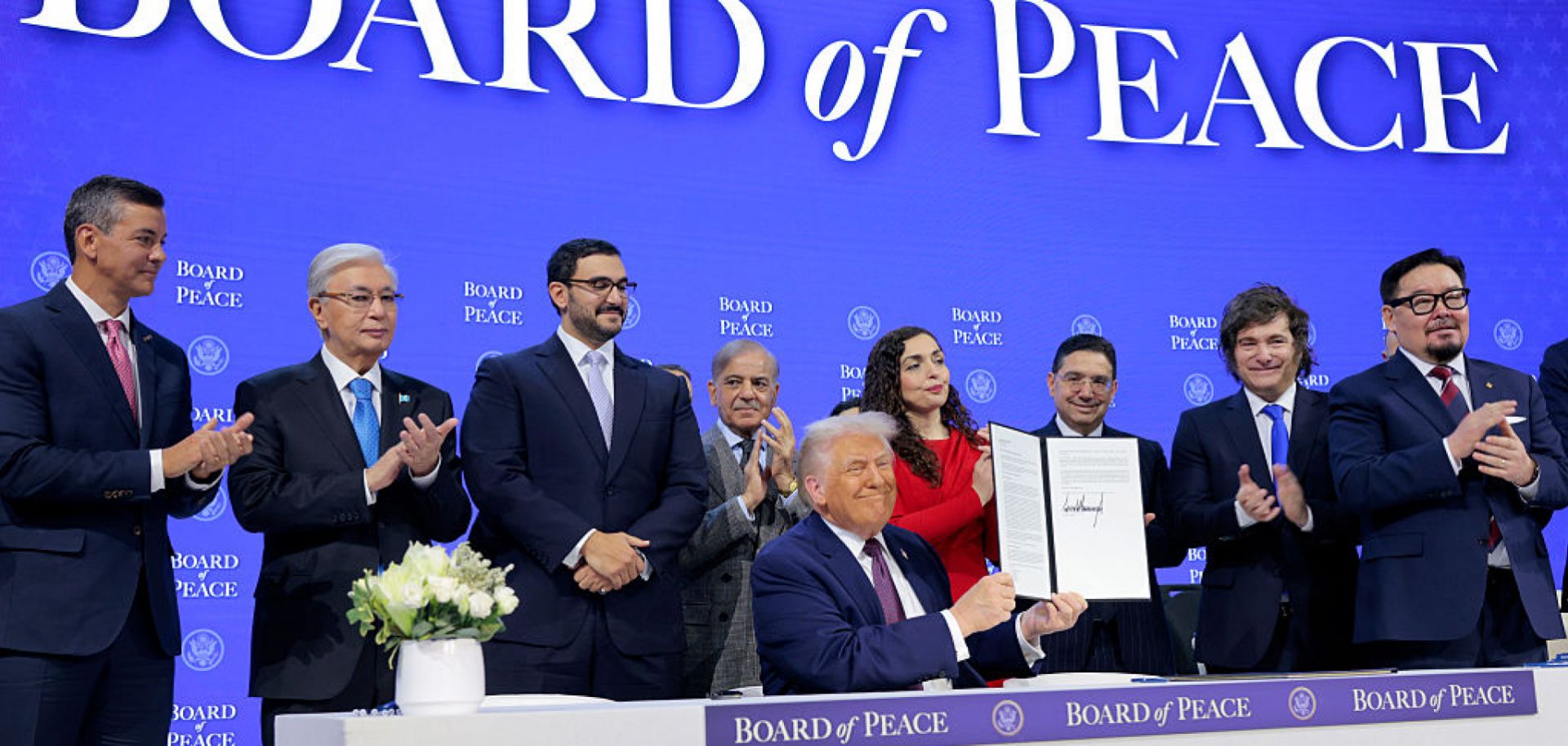 U.S. President Donald Trump (C) holds up his signature on the founding charter of the Board of Peace among other world leaders at the World Economic Forum on Jan. 22 in Davos, Switzerland.