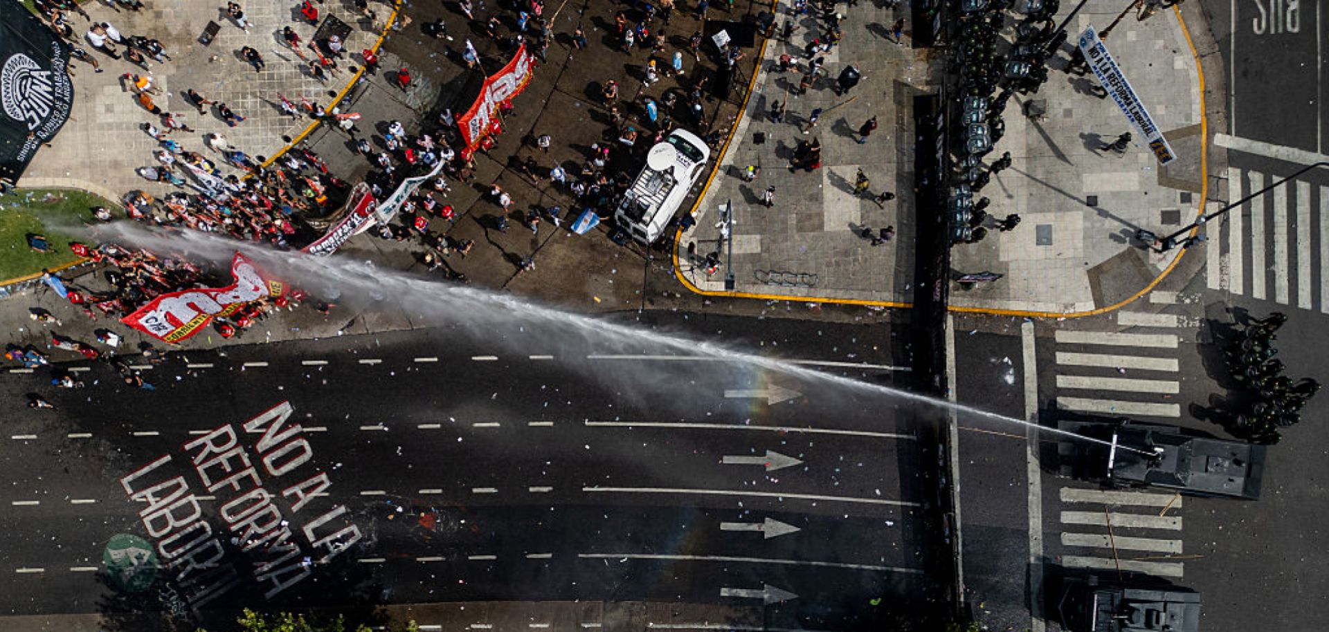 An aerial photo shows Argentinian police using a water cannon truck against protesters opposing labor reforms on Feb. 11, 2026, in Buenos Aires, Argentina.