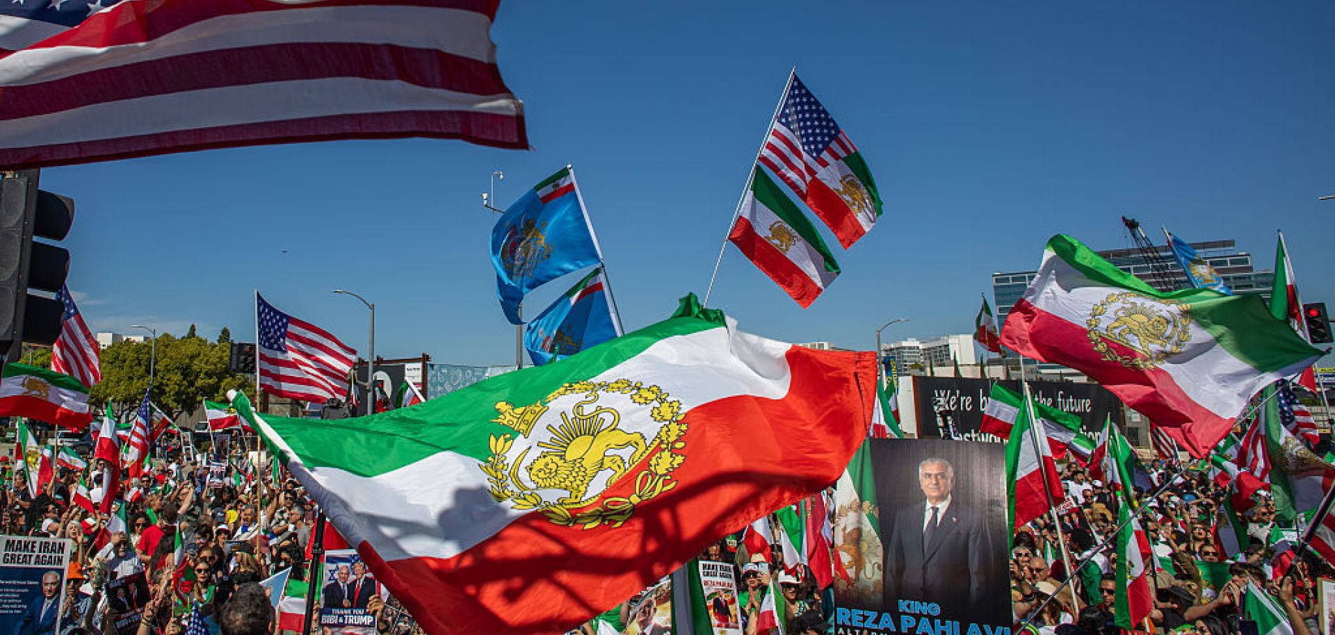 People wave Iranian pre-1979 Islamic Revolution and American flags while members of the Iranian community celebrate in front of the Federal Building on March 1, in Los Angeles. 