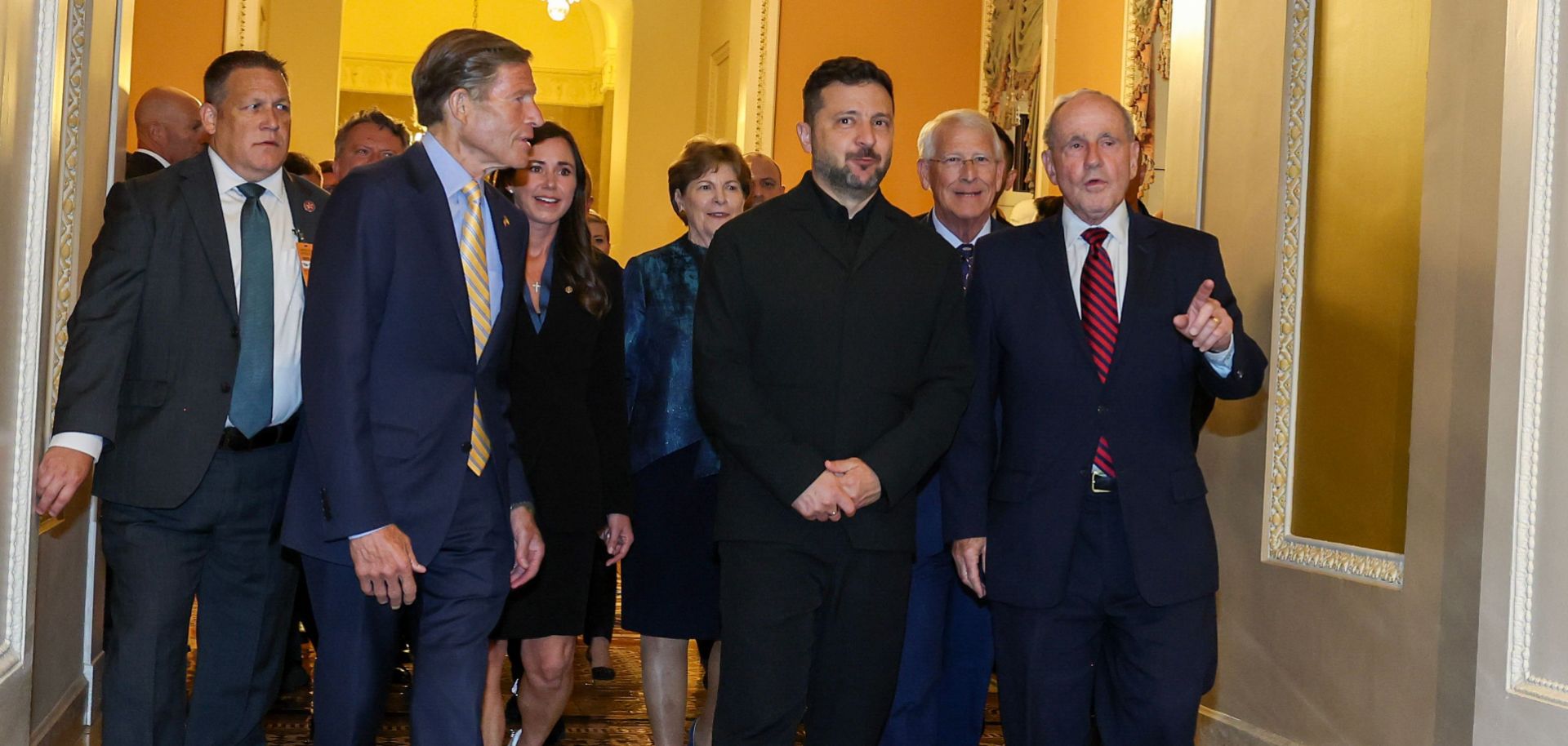 Ukrainian President Volodymyr Zelensky (center) chats with U.S. senators before heading to a closed-door meeting at the U.S. Capitol on July 28, 2026. 