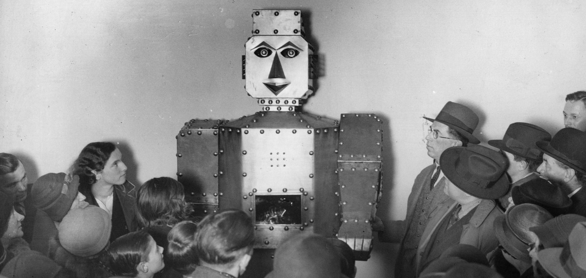 There's more than one way to predict the future, something not lost on shoppers as they admire a fortune-telling robot at Selfridges Store in London, 1934.