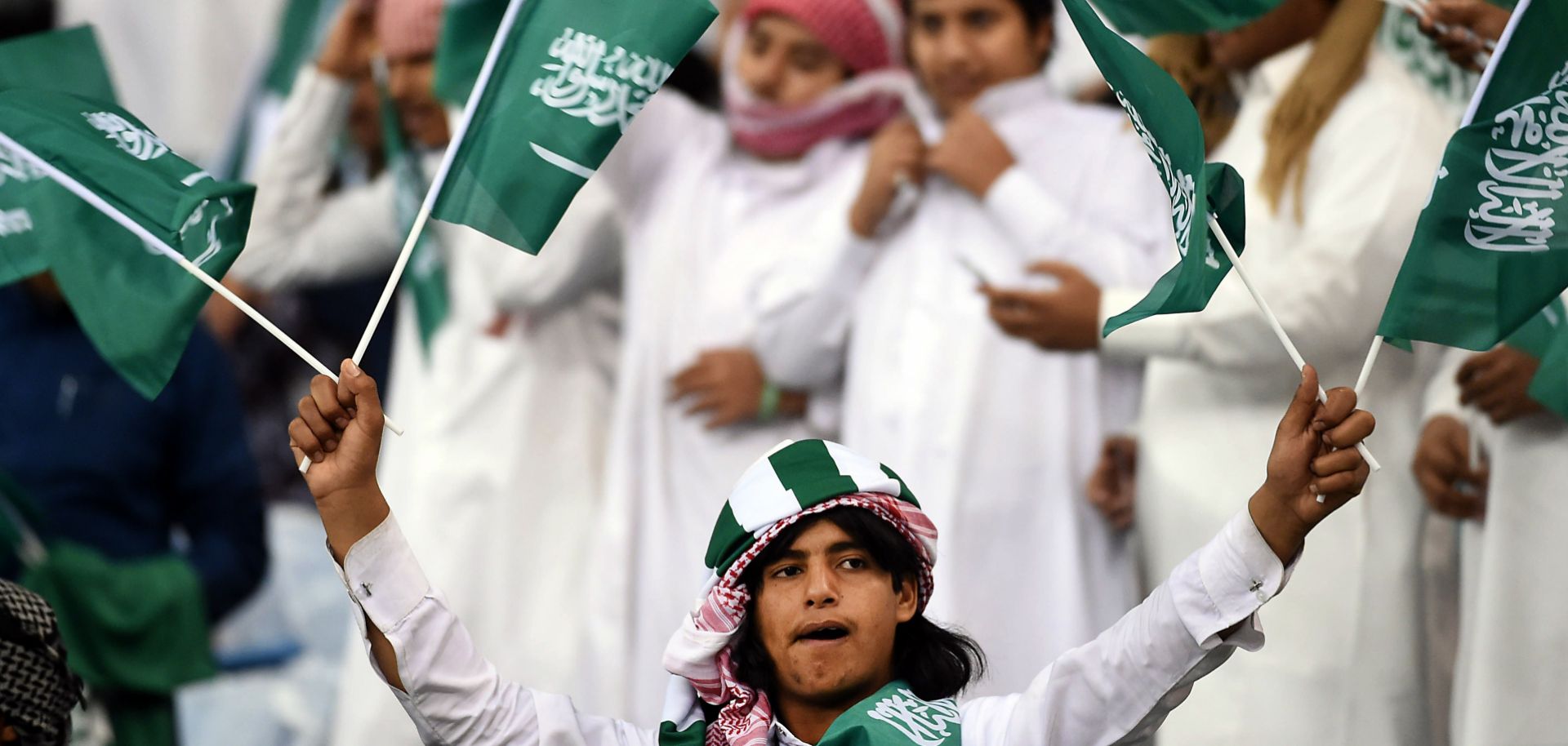 Fans of the Saudi national football team cheer during a match against Qatar at the King Fahad International Stadium in Riyadh, Saudi Arabia, on Nov. 26, 2014.