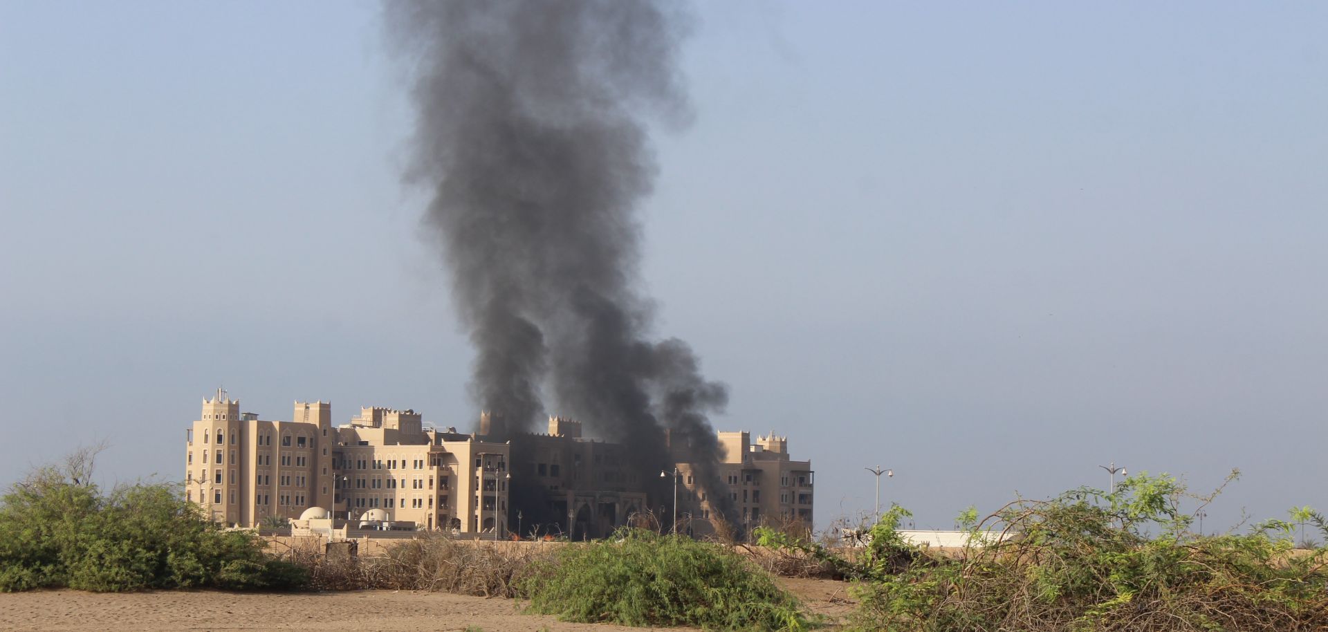 Smoke rises from al-Qasr Hotel, which is hosting top Yemeni officials, after it was hit by a rocket attack on Oct. 6, 2015, in Aden. 