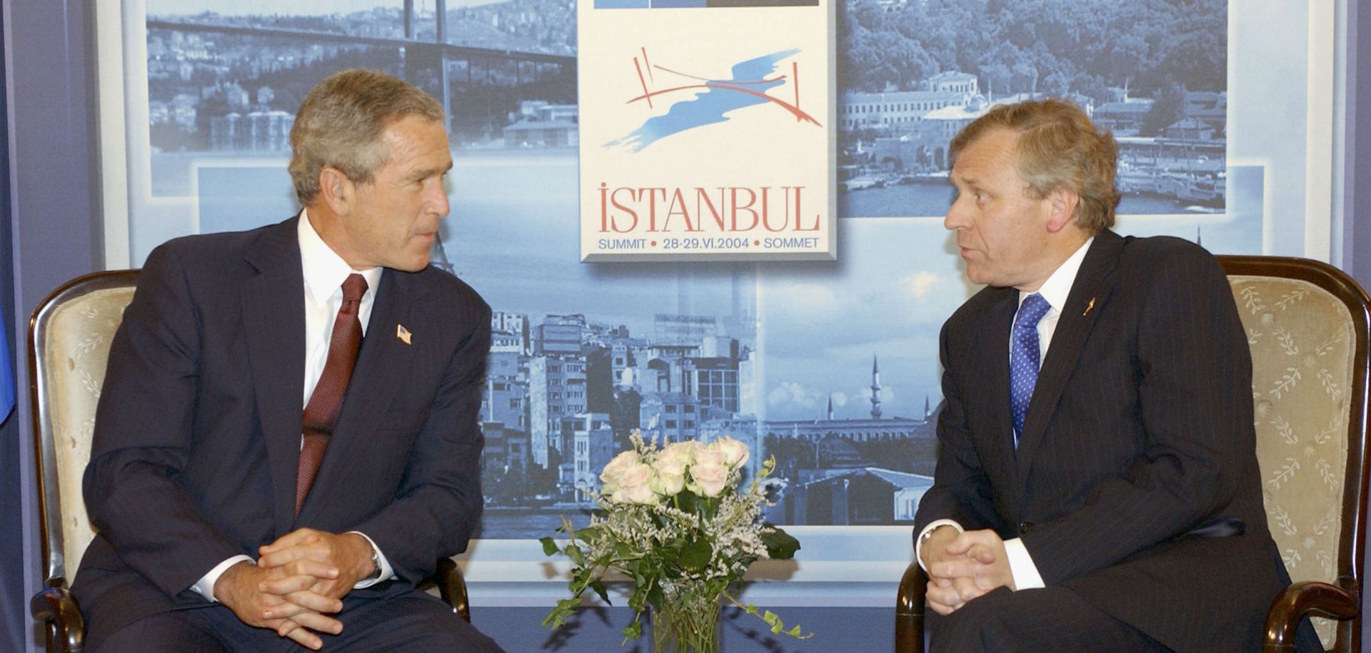 In this handout photo provided by NATO, U.S. President George W. Bush (L) and NATO Secretary-General Jaap de Hoop Scheffer discuss matters during the annual NATO summit on June 27, 2004, in Istanbul. 