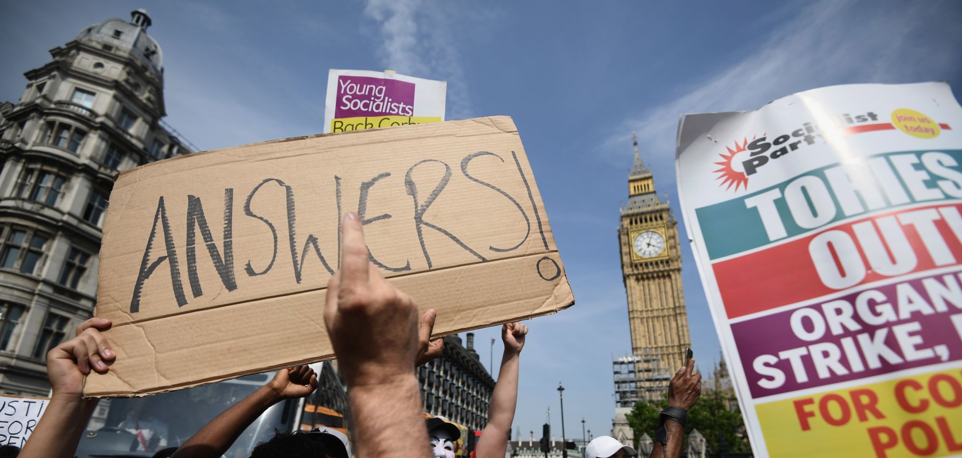 Protesters hold signs calling for a change of government in Parliament Square during an anti-government protest in London on June 21. 
