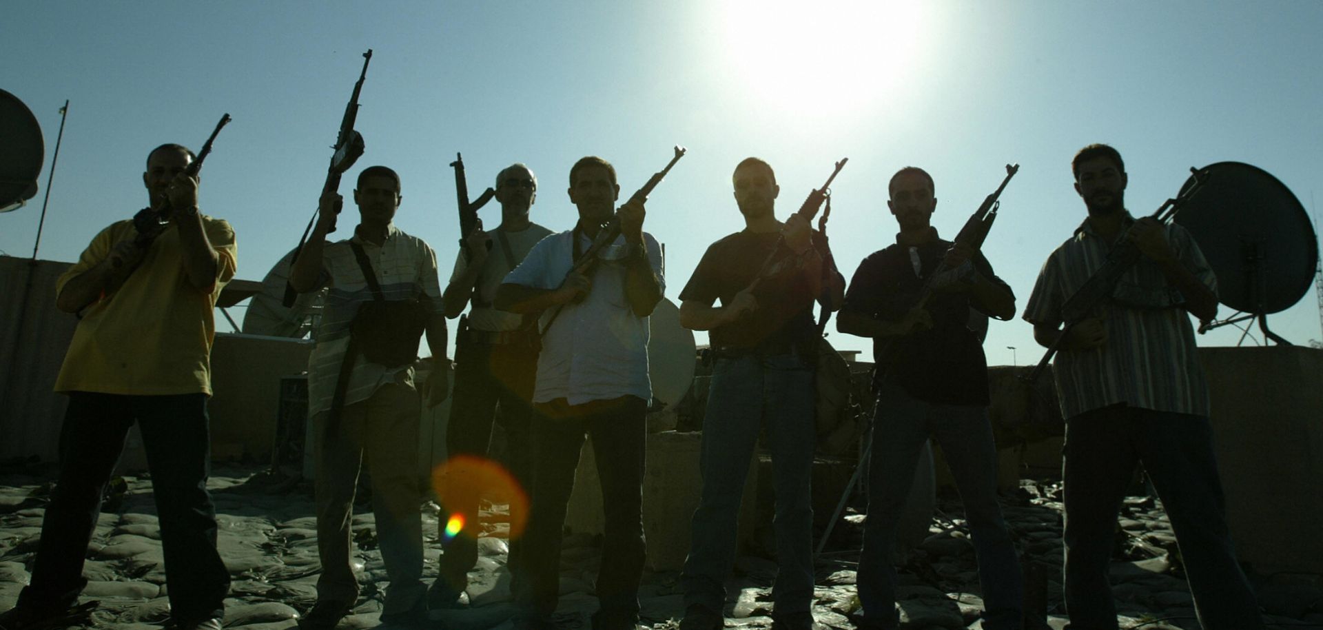 Members of a private security company pose on the rooftop of a house in Baghdad, 18 Sept., 2007. 