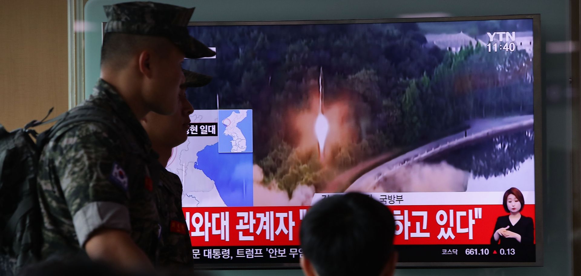 People watch a television broadcast reporting the North Korean missile launch from the Seoul Railway Station in South Korea, on July 4. 
