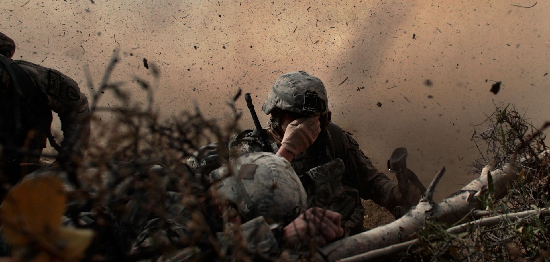  US Army soldiers in the 1/501st of the 25th Infantry Division shield their eyes from the powerful rotor wash of a Chinook cargo helicopter as they are picked up from a mission October 15, 2009 in Paktika Province, Afghanistan. 