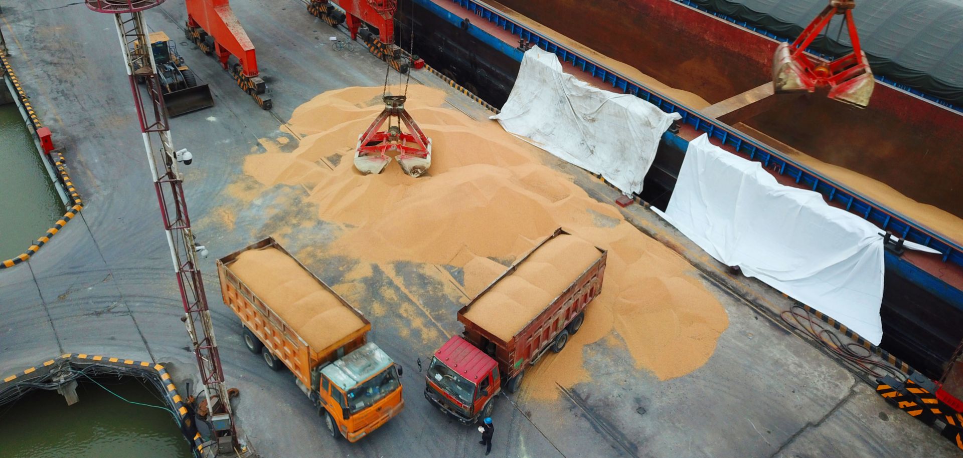 Trucks laden with imported soybeans prepare to depart a port in eastern China in April 2018.