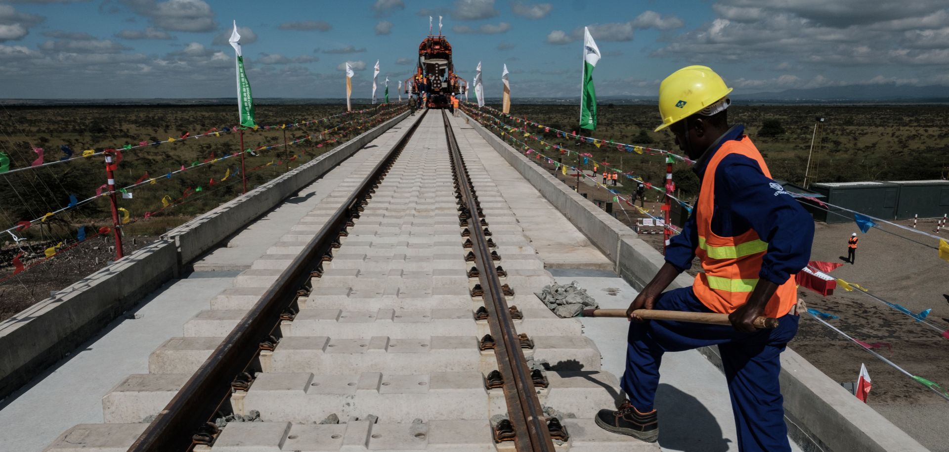 A construction worker adds gravel to the tracks of a section of the new Standard Gauge Railway (SGR) in Nairobi, Kenya, in June 2018. 