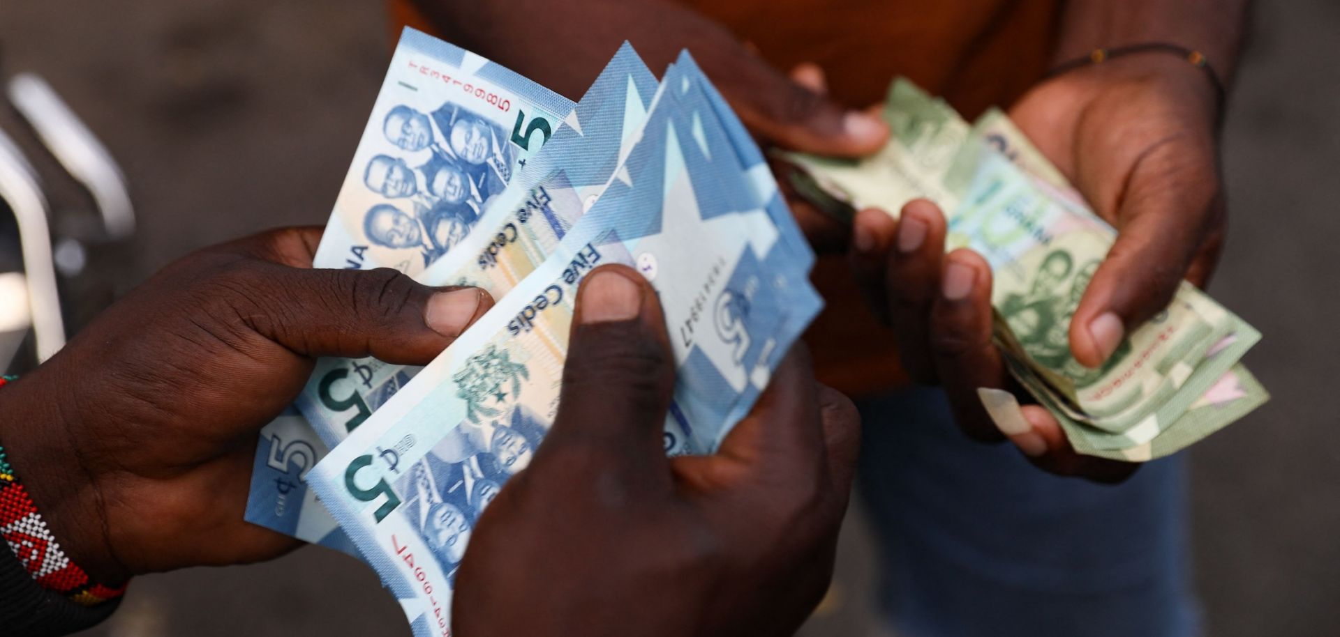 A man holds cedis, the Ghanan currency, notes in Accra, Ghana, on Dec. 1, 2022.