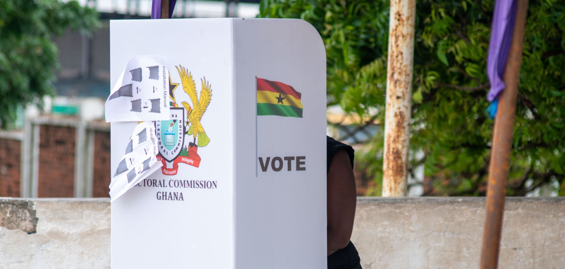 A voter casts their ballot in a voting booth in Ghana in June 2020.