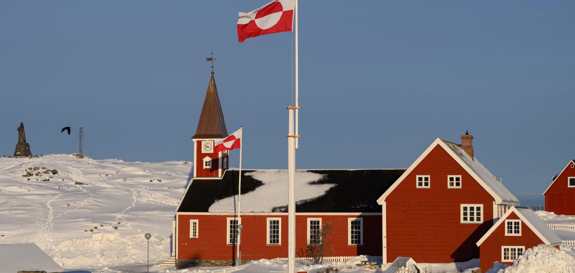 The flag of Greenland, known locally as "Erfalasorput," flies next to the Church of Our Saviour on March 30, 2025, in Nuuk, Greenland. 